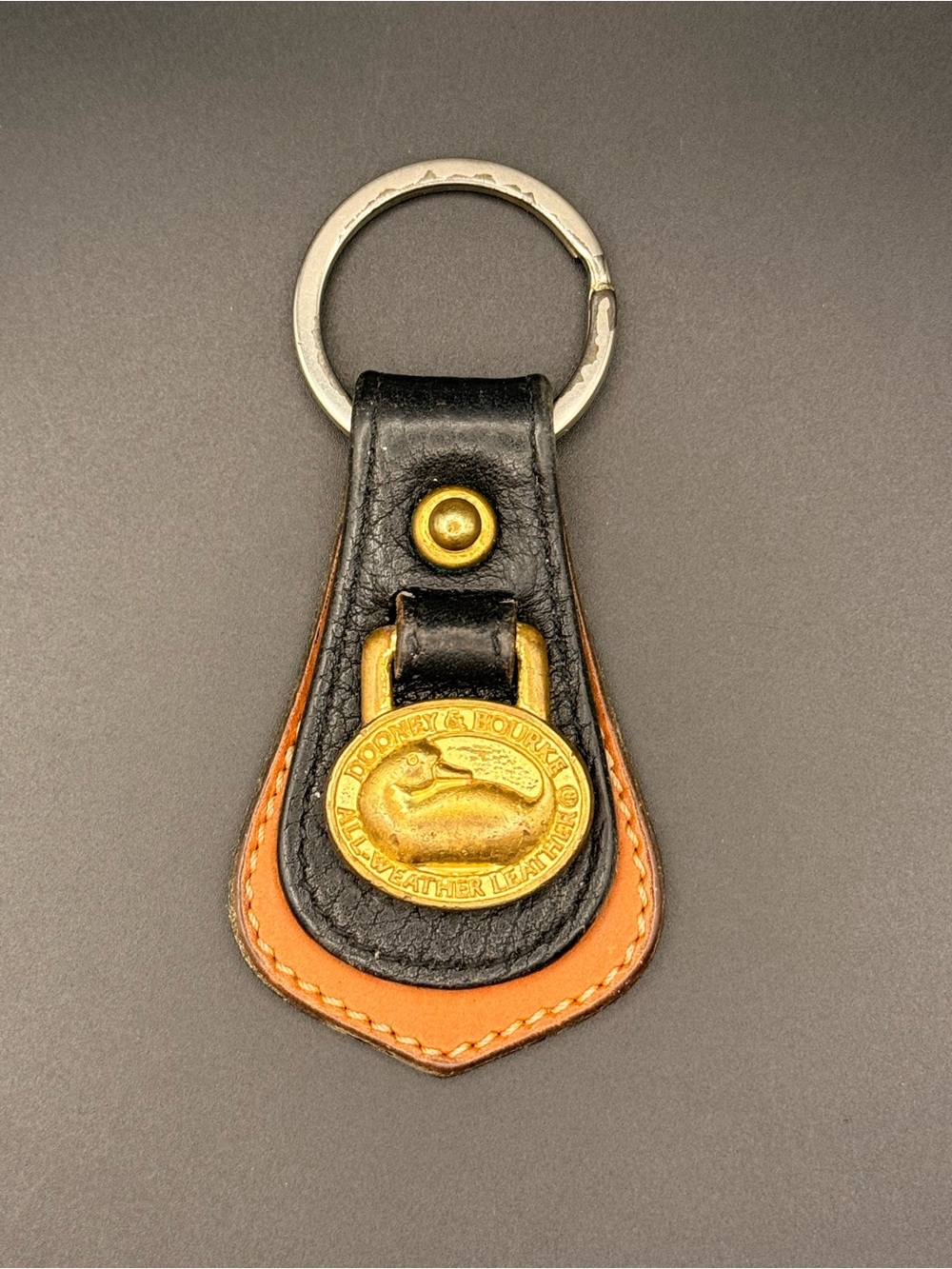 Dooney and Bourke Vintage Black and Tan Leather Keychain with Brass Medallion